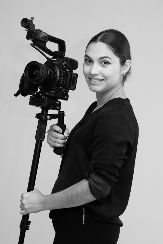 Camerawoman with cinema camera on a monopod